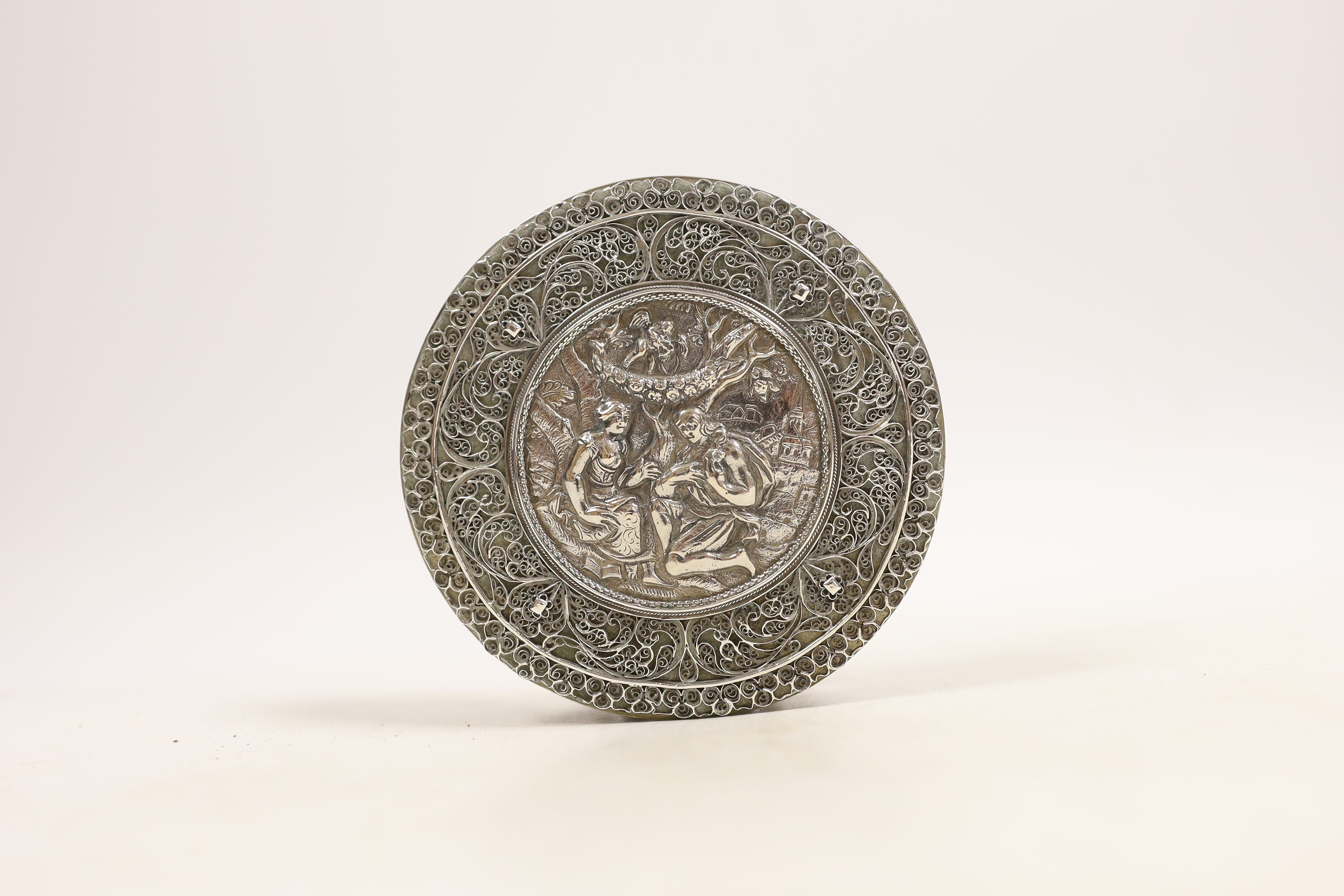 A continental white metal circular box and cover, with applied filigree decoration, diameter 11.2cm, 8.5oz.